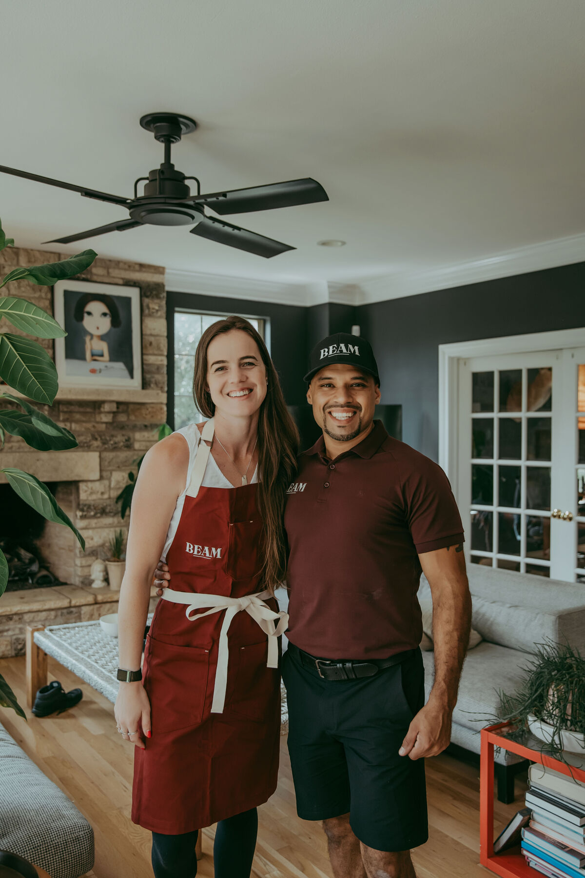 The two founders of Beam Cleaning Co. in a client's living room